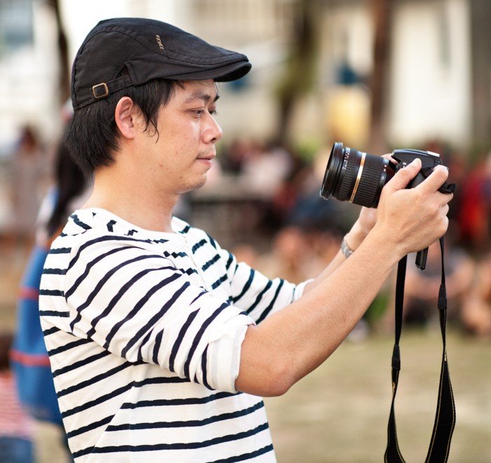 Tips For Travel Photography etiquette in Thailand Photographer at an Outdoor Event
