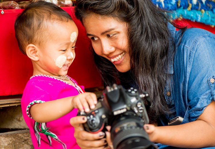 Thai woman and small child with a DSLR camera