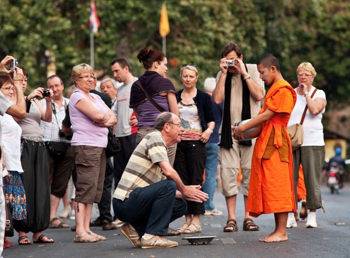Tips For Travel Photography etiquette in Thailand Buddhist Monks Receive Offerings