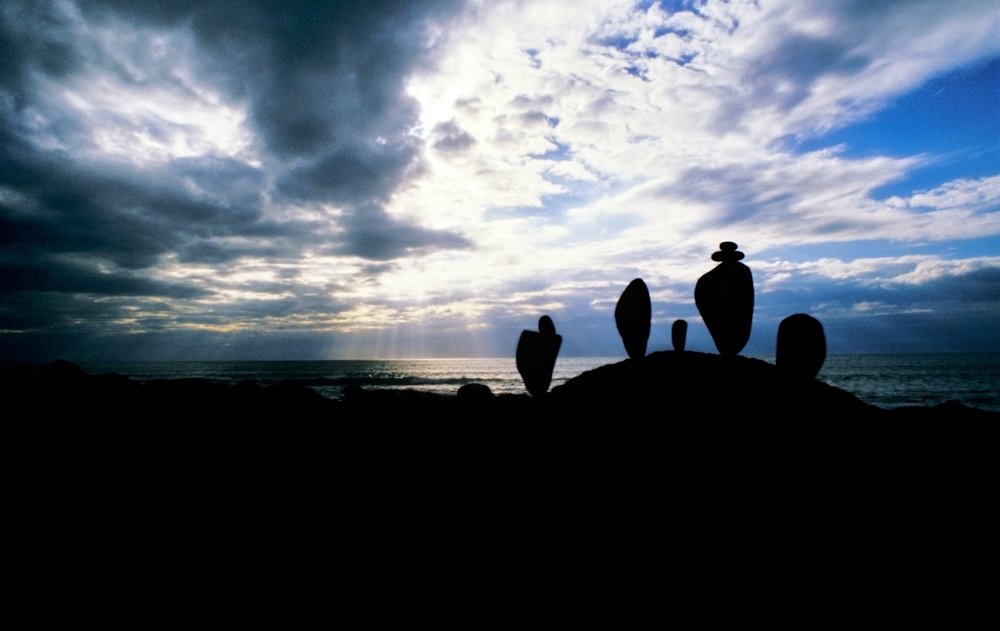 Stacked rocks silhouetted against a moody sky